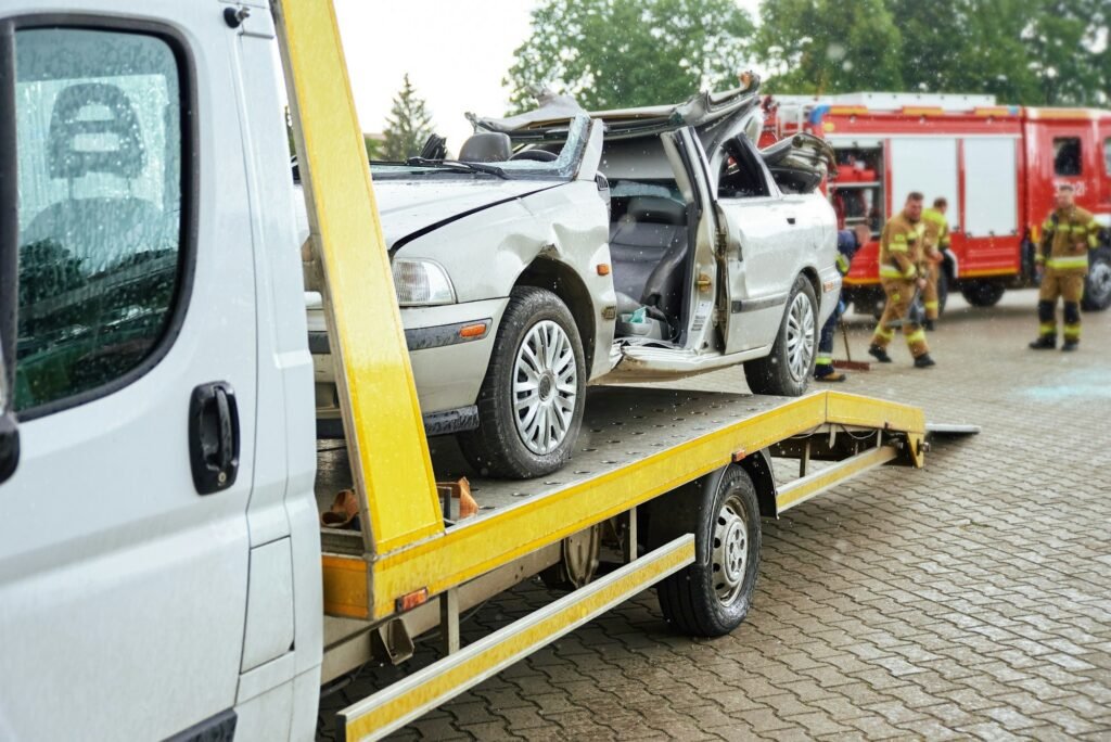 Crashed car loading into tow truck after traffic accident on road